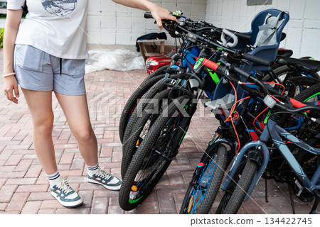 Hand gripping the brake lever of a bicycle handlebar in close-up. Hand gripping the brake lever of a bicycle handlebar in close-up. 134422745