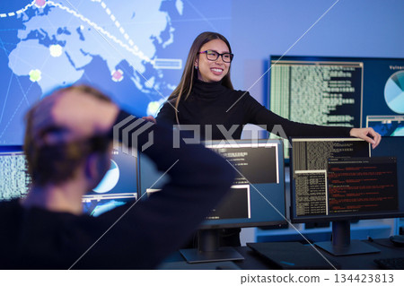 Team analyzing cybersecurity threats in modern security operations center 134423813