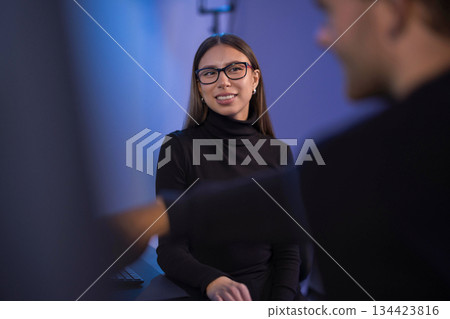 Professional Team Collaborating in a Technology Work Environment for Cybersecurity Tasks 134423816