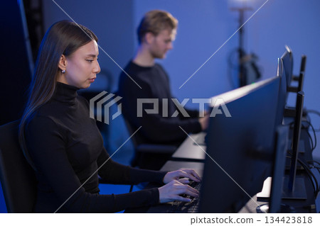 Team collaboration of cybersecurity analysts in a monitoring room environment 134423818