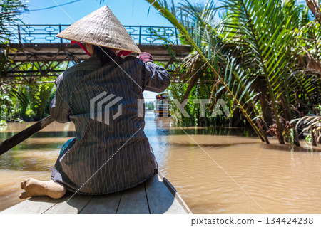 Local Woman Paddling Traditional Canoe Mekong Delta, Vietnam Local Woman Paddling Traditional Canoe Mekong Delta, Vietnam 134424238