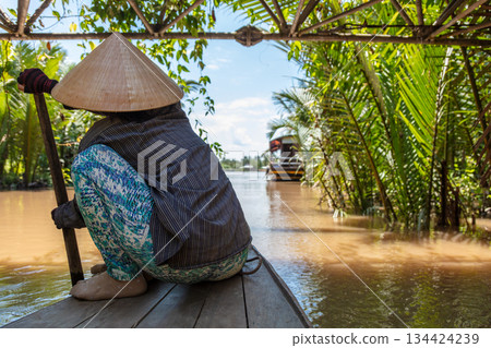Local Woman Paddling Traditional Canoe Mekong Delta, Vietnam 134424239