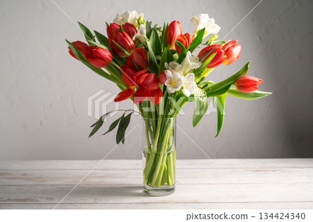Spring floral background. Red tulips and Fresia white flower bouquet. 134424340