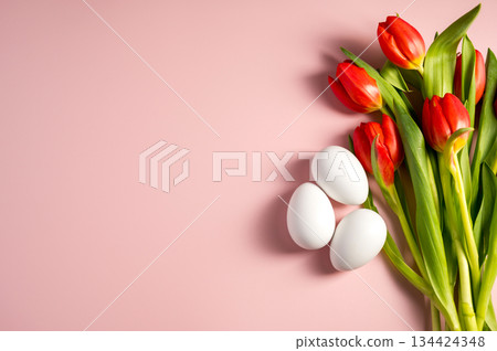 Easter holidays background. Red tulips and easter white eggs on a pink pastel background, copy space. Flat lay 134424348