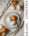 Easter background. Willow branches, white eggs in a plate. Spring time. Minimalistic top view 134424369