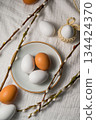 Easter background. Willow branches, white eggs in a plate. Spring time. Minimalistic top view 134424370