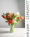 Spring floral background. Red tulips and Fresia white flower bouquet. Copy space 134424377