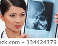 Chinese Female Woman Hospital Doctor Looking at Skull X-Ray 134424379