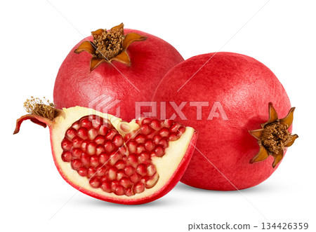 Two ripe pomegranates and cut in a half isolated. Pink fresh pomegranate and chunk isolated. Two ripe pomegranates and cut in a half isolated. Pink fresh pomegranate and chunk isolated. 134426359