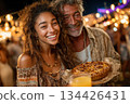 Joyful woman and man holding pie at festive outdoor market celebration 134426431