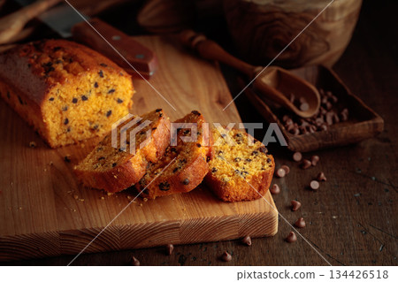 Cake with chocolate pieces on a kitchen table. 134426518