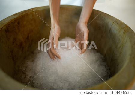 Close up picture of female hands holding spa salt Close up picture of female hands holding spa salt 134426533