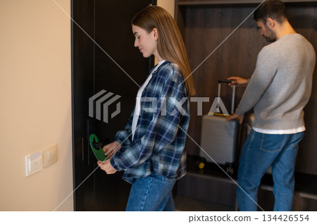 Couple entering the room in the hotel by using card Couple entering the room in the hotel by using card 134426554