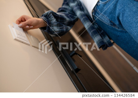 Close up picture of a woman opening the room in the hotel by security card Close up picture of a woman opening the room in the hotel by security card 134426584