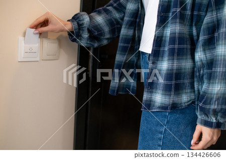 Close up picture of a woman opening the room in the hotel by security card Close up picture of a woman opening the room in the hotel by security card 134426606