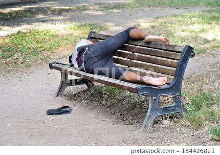 homeless taking a resti on a bench homeless taking a resti on a bench 134426821