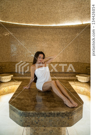 Long-haired pretty woman in spa center feeling wonderful 134426854