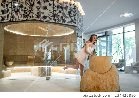 Long-haired pretty woman in spa center feeling wonderful 134426856