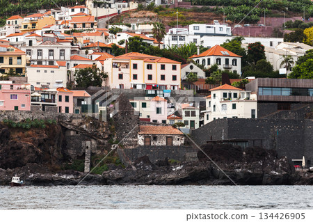 Madeira, vibrant seaside townscape of pastel and white houses with red roofs 134426905