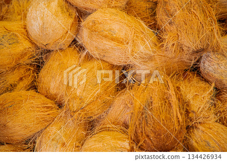 background Heap of peeled brown coconut cocos nucifera kept for sale. 134426934