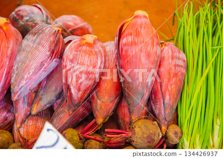 Young large red Banana blossom. Asian cuisine ingredient and natural background Young large red Banana blossom. Asian cuisine ingredient and natural background 134426937