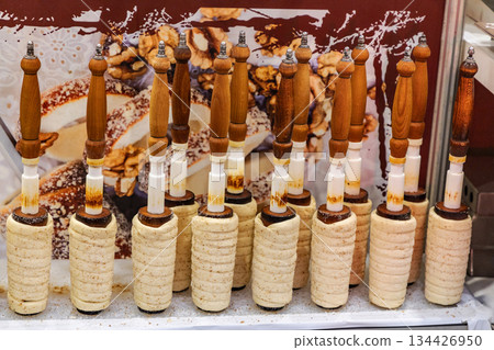 Traditional pastry tools lined up on display with sweet treats in background Traditional pastry tools lined up on display with sweet treats in background 134426950