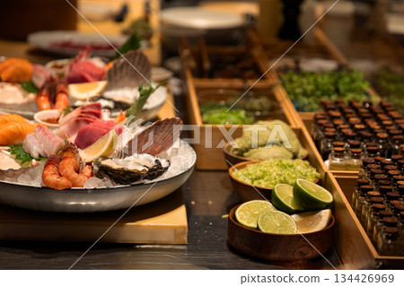 Fresh seafood platter with assorted shellfish and garnishes on display Fresh seafood platter with assorted shellfish and garnishes on display 134426969