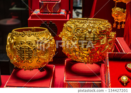Golden Chinese bracelets with intricate designs displayed Golden Chinese bracelets with intricate designs displayed 134427201