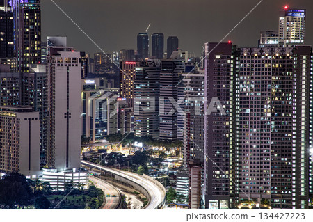 Night cityscape with illuminated skyscrapers and highway 134427223