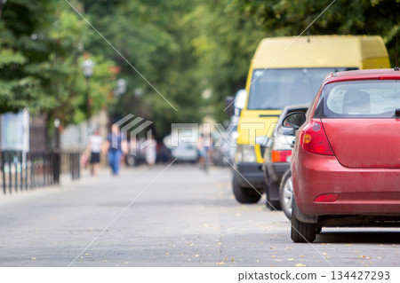 Kyiv, Ukraine - October 14, 2019: Row of cars parked near curb on the side of the street on a parking lot. Kyiv, Ukraine - October 14, 2019: Row of cars parked near curb on the side of the street on a parking lot. 134427293