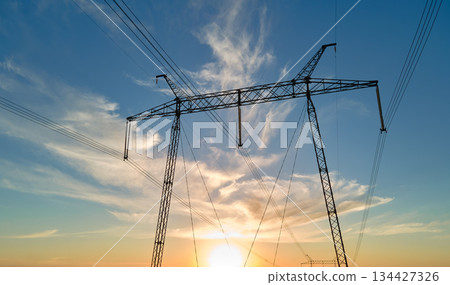 High voltage tower with electric power lines at sunset. Transmission of electricity 134427326