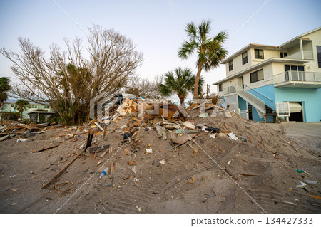 Heaps of debris rubbish on street side near severely damaged by hurricane Milton houses in Florida residential area on Manasota Key in Englewood. Consequences of natural disaster Heaps of debris rubbish on street side near severely damaged by hurricane Milton houses in Florida residential area on Manasota Key in Englewood. Consequences of natural disaster 134427333