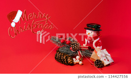 Festive Snowman and Pine Cones on Red Christmas Background Festive Snowman and Pine Cones on Red Christmas Background 134427556