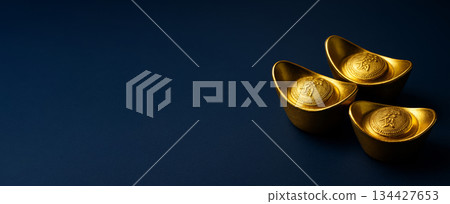 Chinese New Year decor with gold ingots on blue background Chinese New Year decor with gold ingots on blue background 134427653