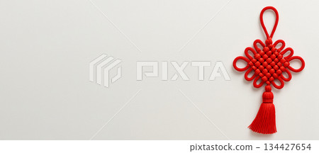 Chinese New Year decor with red knot on white background Chinese New Year decor with red knot on white background 134427654