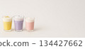 Three colorful beverages in glass cups on light background 134427662