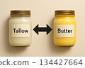 Tallow versus butter concept with arrow between jars on beige background Tallow versus butter concept with arrow between jars on beige background 134427664