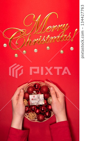 Christmas Basket with Red and Gold Decorations on Red Background Christmas Basket with Red and Gold Decorations on Red Background 134427763