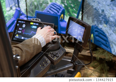 Berlin, Germany - January 22, 2024: Operator using advanced machinery control panel Berlin, Germany - January 22, 2024: Operator using advanced machinery control panel 134427915