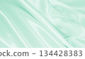 Smooth elegant green silk or satin luxury cloth texture as abstract background. Luxurious background design 134428383