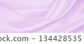 Smooth elegant lilac silk or satin texture as wedding background. Luxurious background design 134428535