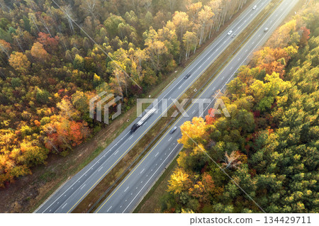 Elevated view of freeway road lanes between autumn mountain hills. Interstate transportation infrastructure in USA 134429711