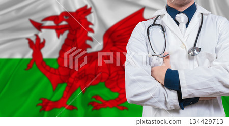 Male doctor with stethoscope on Wales flag. Doctor holding stethoscope on Wales flag 134429713