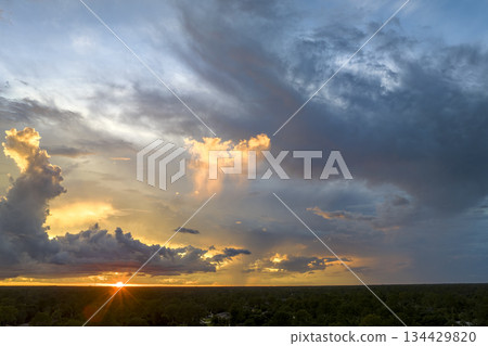 Colorful evening landscape with soft pastel coloured clouds on watercolor tinted sunset sky. Abstract nature background Colorful evening landscape with soft pastel coloured clouds on watercolor tinted sunset sky. Abstract nature background 134429820