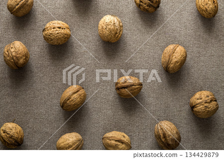 Close-up of walnuts in wooden shell isolated on light copy space background, top view. Healthy tasty organic food concept. 134429879