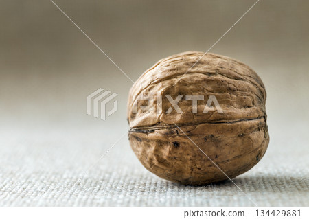 Close-up of walnut in wooden shell isolated on light copy space background. Healthy tasty organic food concept. 134429881