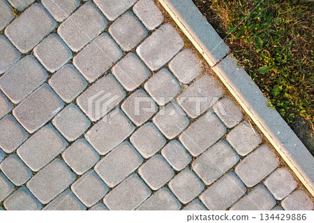 Close-up of slab stone paved path way at park or backyard. Walkway footpath road at house yard garden. Close-up of slab stone paved path way at park or backyard. Walkway footpath road at house yard garden. 134429886