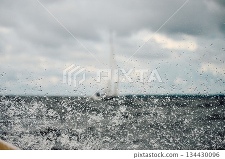 splashing water from under the boat, teamwork, Sailing regatta in the Gulf of Finland at cloudy day, sailing yacht competing in a race, splashing water from under the boat, teamwork, Sailing regatta in the Gulf of Finland at cloudy day, sailing yacht competing in a race, 134430096