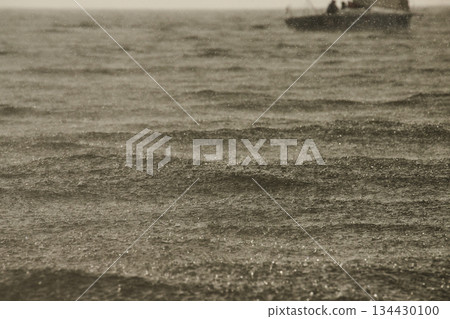 Sailing regatta in the Gulf of Finland in heavily rain, few sailing yachts competing in a race, splashing water from under the boats, teamwork, board the boat Sailing regatta in the Gulf of Finland in heavily rain, few sailing yachts competing in a race, splashing water from under the boats, teamwork, board the boat 134430100