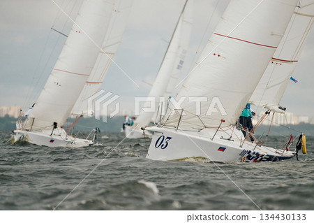 bow of a sailing boats with bowsprit at sailing regatta in the Gulf of Finland at sunny day, sailing yacht competing in a race, splashing water from under the boat, teamwork, board the boat 134430133